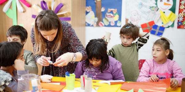 Disabled children in class while teacher is helping them