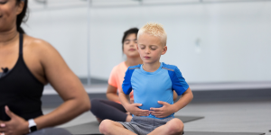 Two children in a breathing class with their teacher
