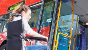 lady in a wheelchair waiting to boarding a bus